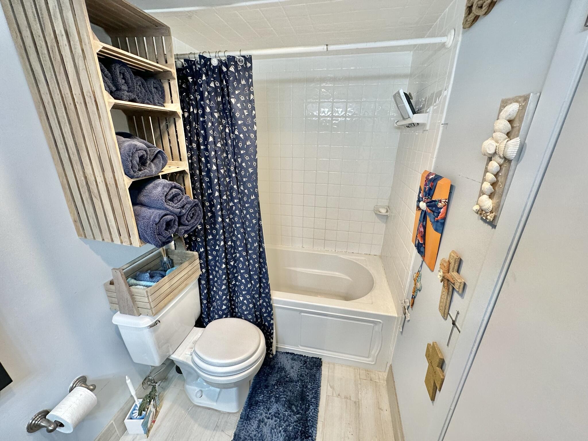 4280 Beachside 2, Unit 280 Miramar Beach, FL 32550 - Photo 5 of 34 a white toilet sitting next to a bathroom sink and tub