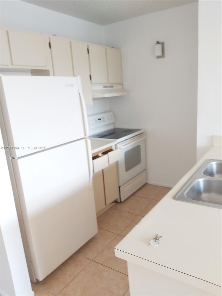 2501 Riverside Drive, Unit 212A Coral Springs, FL 33065 - Photo 6 of 7 a utility room with dryer and washer