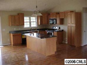 3540 Mack Ballard Road Maiden, NC 28650 - Photo 3 of 4 a kitchen with stainless steel appliances granite countertop a refrigerator a sink a stove and island