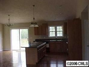 3540 Mack Ballard Road Maiden, NC 28650 - Photo 4 of 4 a kitchen with granite countertop a stove a sink and a window