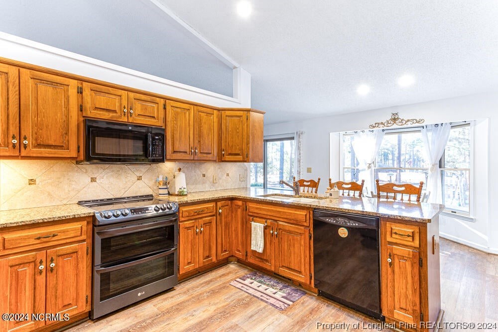 Undisclosed Address West End, NC 27376 - Photo 18 of 49 a kitchen with stainless steel appliances granite countertop a stove sink microwave and refrigerator