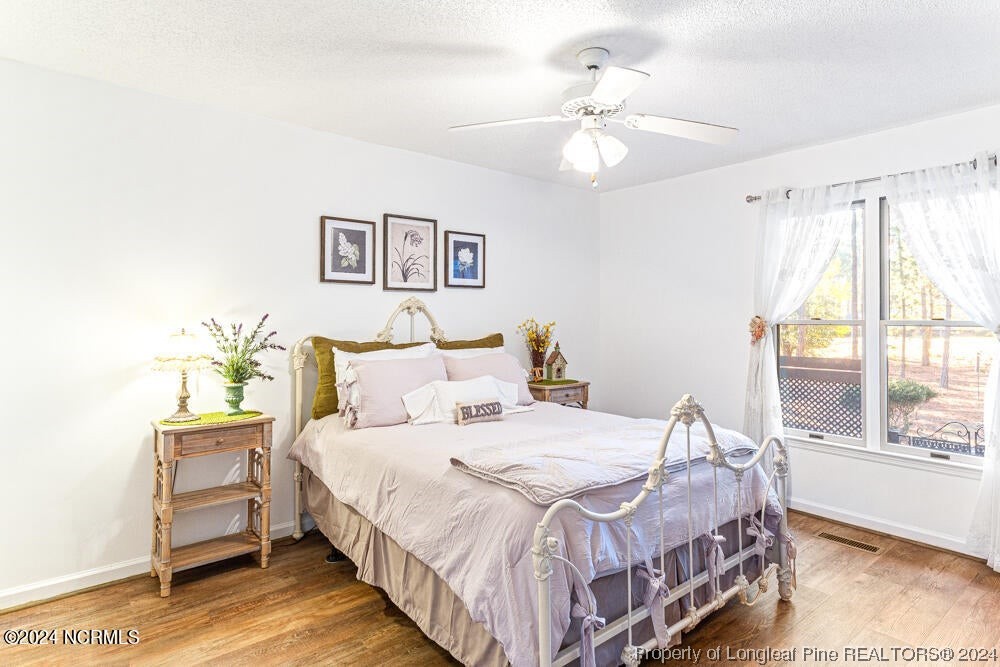 Undisclosed Address West End, NC 27376 - Photo 28 of 49 a bedroom with a bed and a chandelier