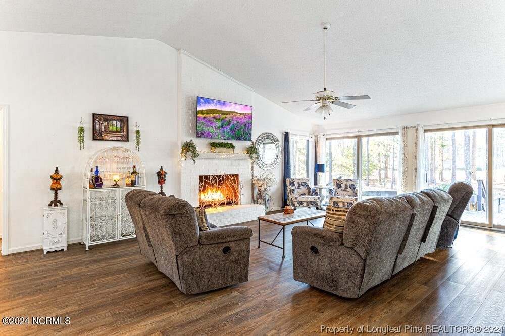 Undisclosed Address West End, NC 27376 - Photo 9 of 49 a living room with fireplace furniture and a wooden floor