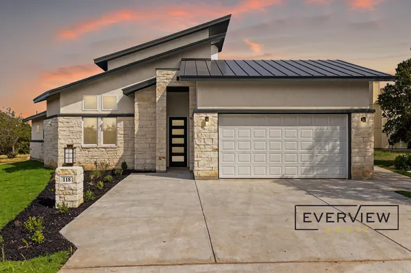 a front view of a house with garage