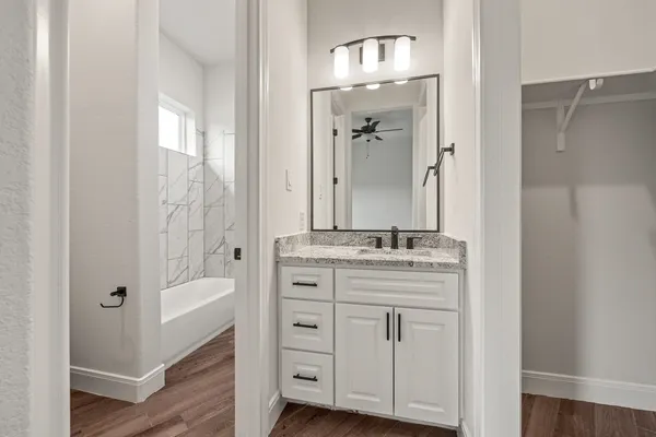 a bathroom with a double vanity sink and mirror with shower