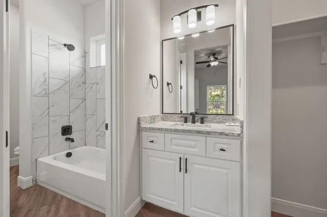 a bathroom with a bathtub a sink and a mirror