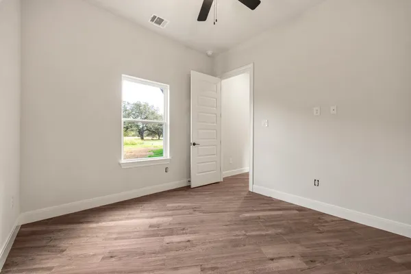 wooden floor in an empty room with a window