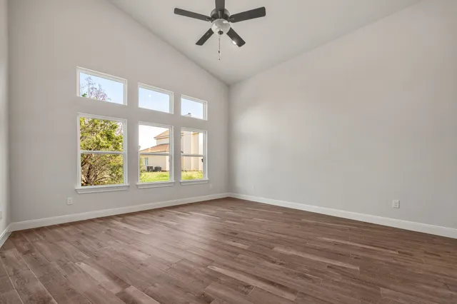 wooden floor in an empty room with a window