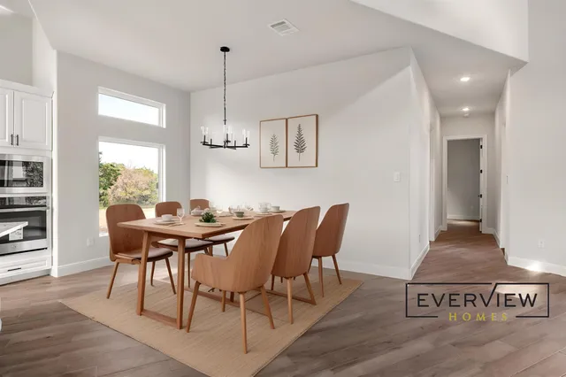 a view of a dining room with furniture window and wooden floor