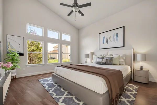 a spacious bedroom with a bed and a window