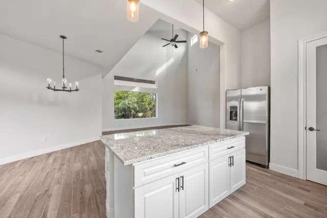 a kitchen with a sink a counter space and a window