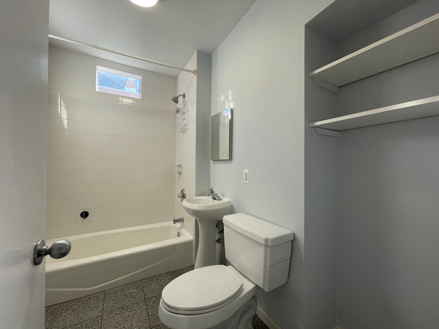 1819 South May Street, Unit 1 Chicago, IL 60608 - Photo 7 of 7 a white toilet sitting next to a bath tub