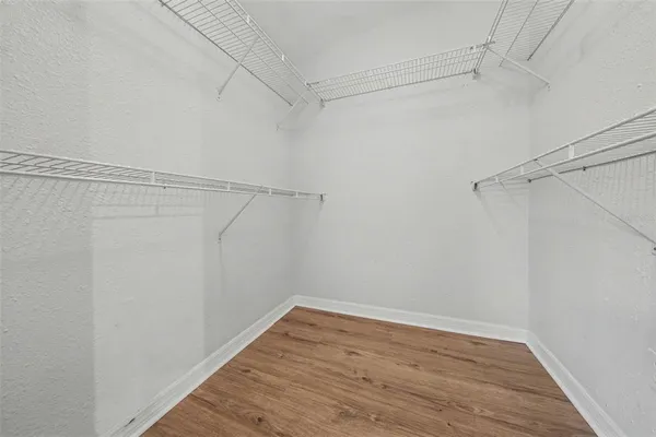 a view of a room with wooden floor