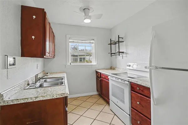 a kitchen with a sink stove and cabinets