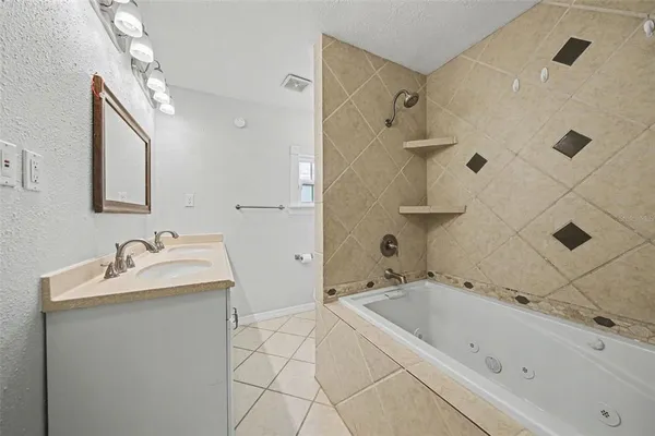 a bathroom with a tub sink and mirror