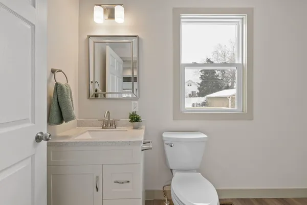 a bathroom with a toilet sink and mirror