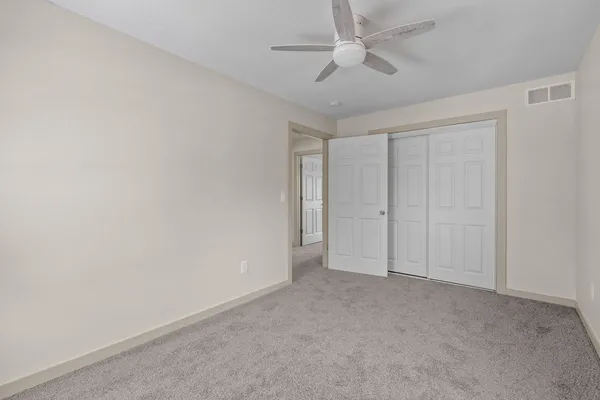 an empty room with a ceiling fan and a ceiling fan