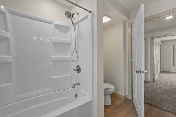 a bathroom with a bathtub and a shower