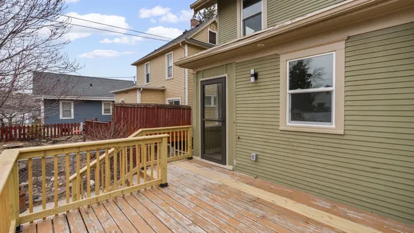 a view of balcony with wooden floor and fence