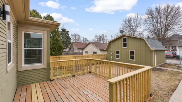 a black white and white photo of a small white house
