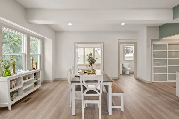 a view of a dining room with furniture and wooden floor