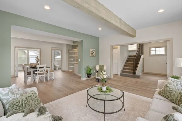 a living room with furniture and a wooden floor