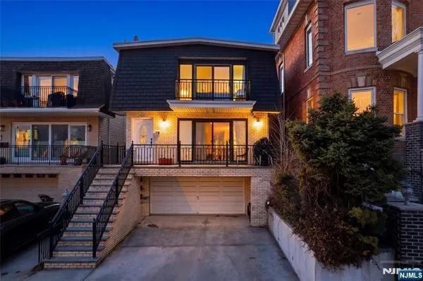 a view of a house with backyard and balcony