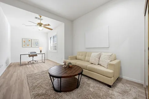 a living room with furniture and a dining table