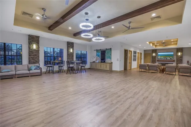 a kitchen with a sink dishwasher stove and white cabinets with wooden floor