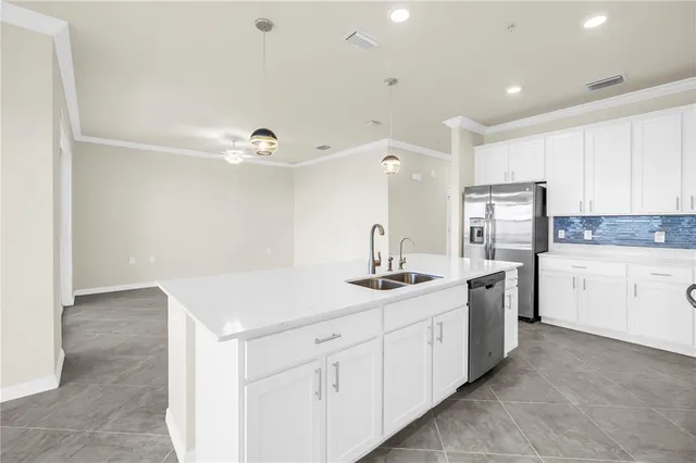 an empty room with a fan & a ceiling fan