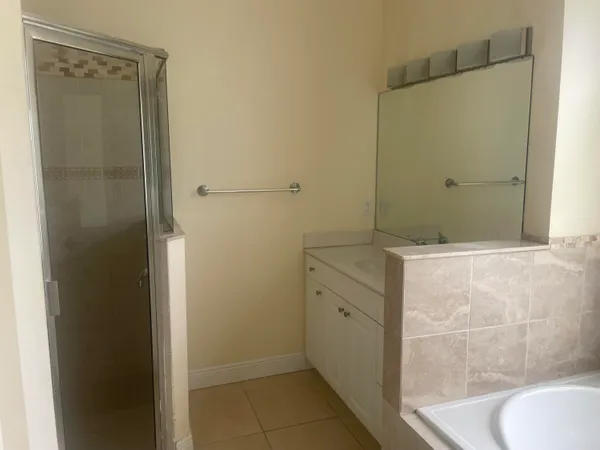 a bathroom with a shower and a sink