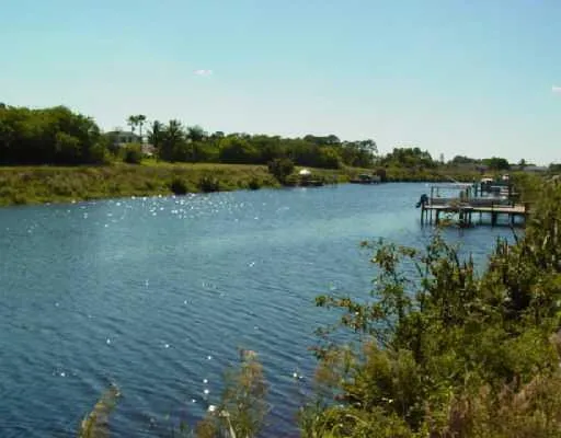 a view of a lake with table and chairs