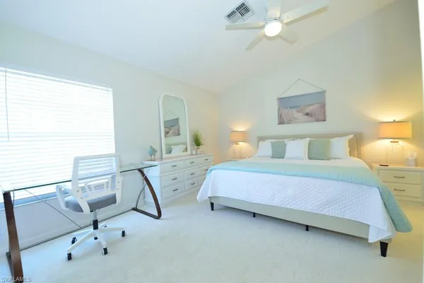a bedroom with a bed a desk and chair