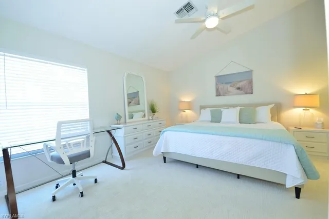 a bedroom with a bed a desk and chair