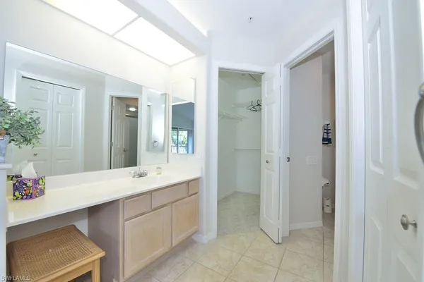 a spacious bathroom with a double vanity sink and a mirror