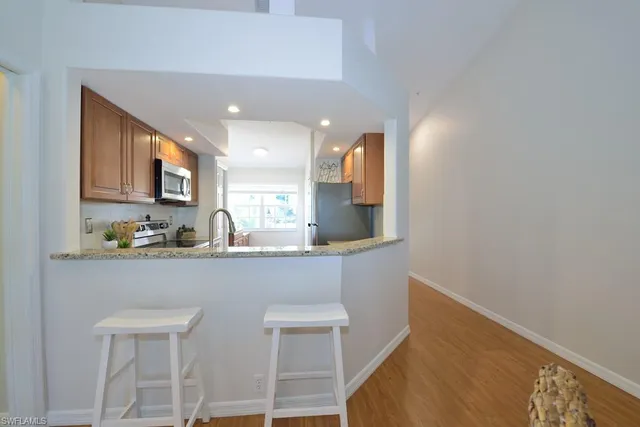 a kitchen with cabinets a sink and appliances