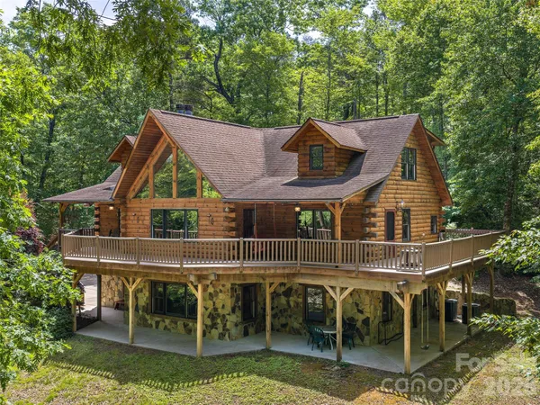 an aerial view of a house with swimming pool and patio