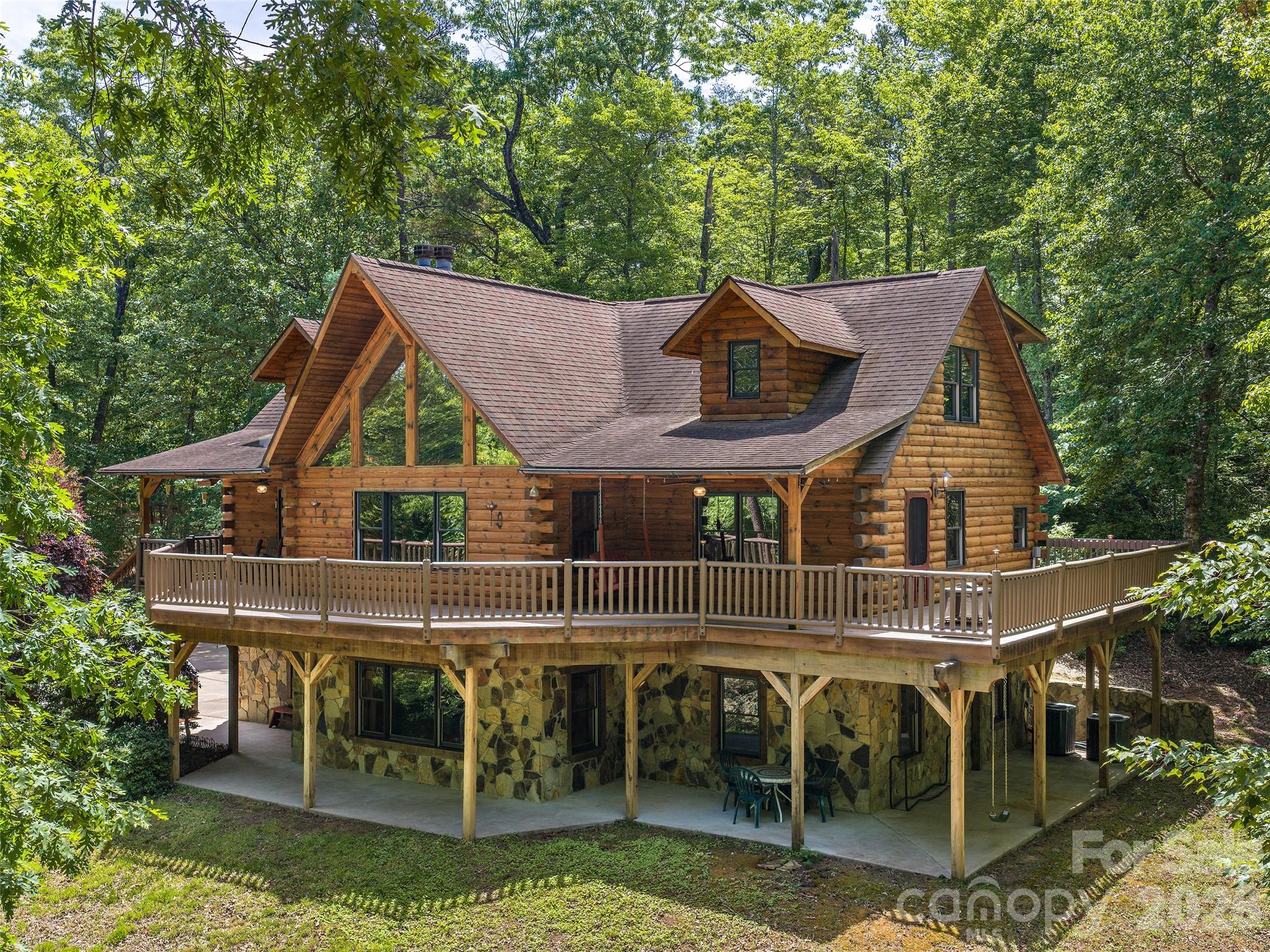 an aerial view of a house with swimming pool and patio