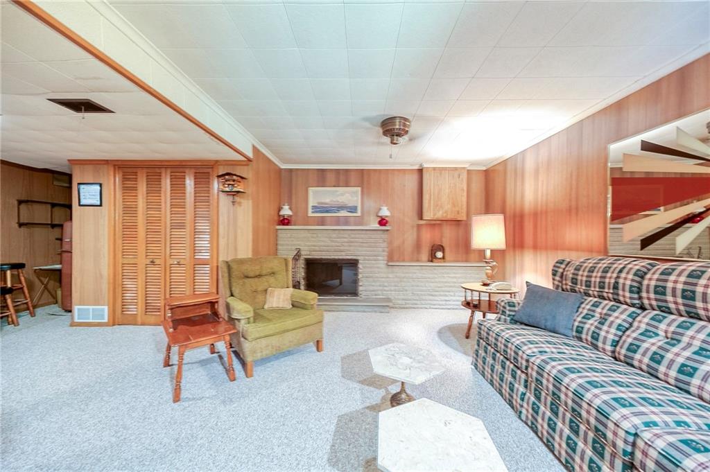 36 Roxbury Road Pittsburgh, PA 15221 - Photo 19 of 24 Step into a spacious family room designed for cozy relaxation. The centerpiece of the space is a wood-burning fireplace.