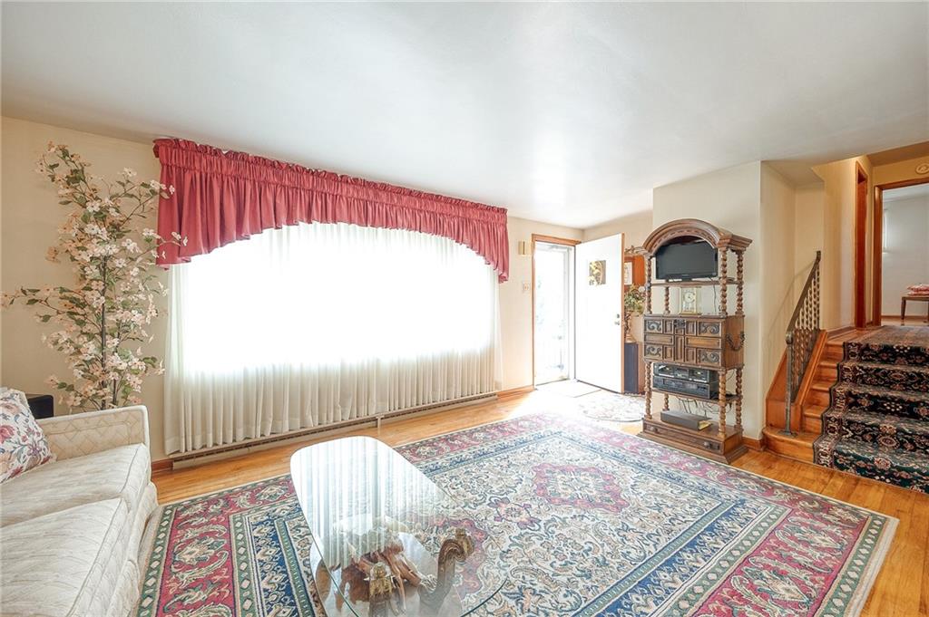 36 Roxbury Road Pittsburgh, PA 15221 - Photo 3 of 24 The large window dominates one wall of this inviting living room, flooding the space with natural light and creating a sense of openness.