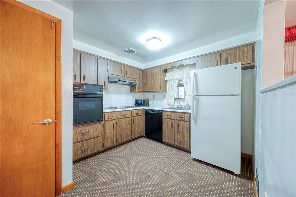 36 Roxbury Road Pittsburgh, PA 15221 - Photo 5 of 24 Enjoy cooking in the equipped kitchen and take a glimpse out to the sun room through the window at the kitchen sink