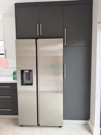 a kitchen with a refrigerator and cabinets