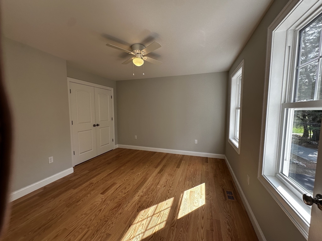 56 Dudley Road Billerica, MA 01821 - Photo 14 of 29 wooden floor in an empty room with a window