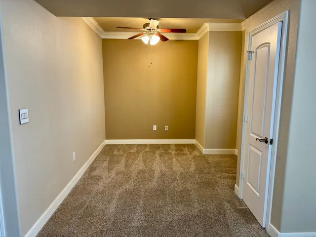 a view of room with a ceiling fan