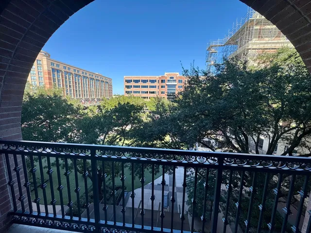 a view of a balcony with wooden fence and floor