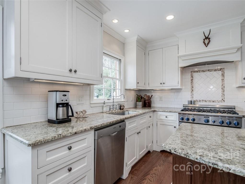 416 Whitestone Road Charlotte, NC 28270 - Photo 13 of 28 a kitchen with granite countertop a sink a stove and cabinets