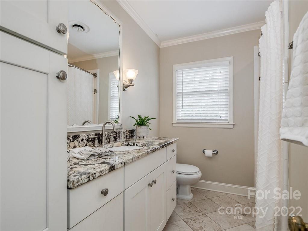 416 Whitestone Road Charlotte, NC 28270 - Photo 22 of 28 a bathroom with a granite countertop sink a toilet a mirror and a window