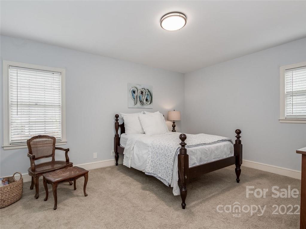 416 Whitestone Road Charlotte, NC 28270 - Photo 23 of 28 a bedroom with a bed and a chair