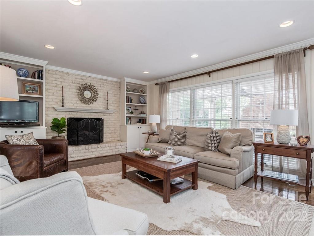 416 Whitestone Road Charlotte, NC 28270 - Photo 8 of 28 a living room with furniture a large window and a fireplace