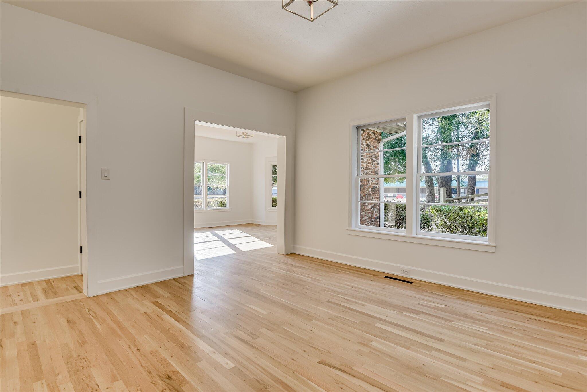 126 Mosley Road Aiken, SC 29801 - Photo 7 of 29 a view of an empty room with wooden floor and a window